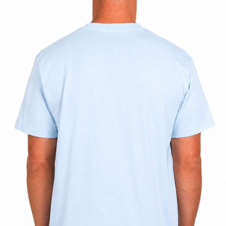 Male model wearing a light blue Sandtrap T-shirt shown from the back with a blank design. Photographed against a clean white studio background to showcase the fit and silhouette.