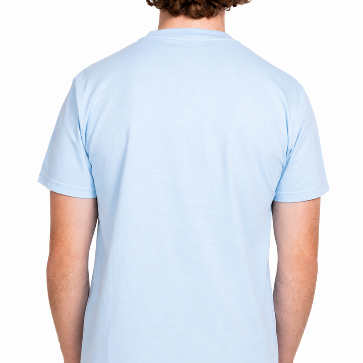 Male model shown from the back wearing a light blue Sandtrap T-shirt with a blank back panel. The relaxed-fit tee is displayed against a clean white studio background
