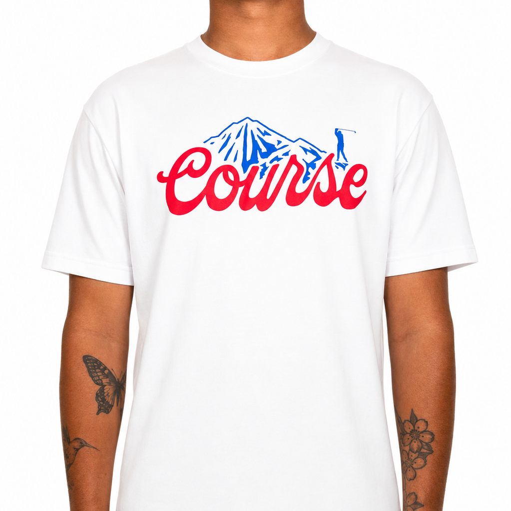 Male model wearing a white Sandtrap T-shirt featuring a large red “Course” script graphic with a blue mountain illustration across the chest. The relaxed-fit tee is shown against a clean studio background to highlight the fit, color contrast, and front artwork.