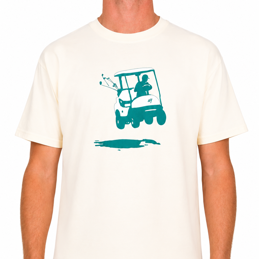 Male model wearing an off-white Sandtrap T-shirt featuring a teal golf cart graphic centered on the chest. Shown from the front against a clean studio background.